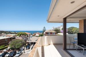 a balcony with a view of a city at Dream View Steps from the Beach in Sydney