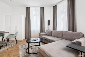 a living room with a couch and a table at easy-flat Rokitanskygasse - Apartments near Tram 43 to City Center in Vienna