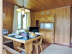 Un comedor con una mesa y un televisor. en Apartment Chalet Colette-1 by Interhome, en Grindelwald