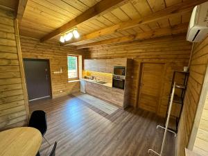 a large room with wooden walls and a wooden floor at Ranczo Mokre in Łopuszno
