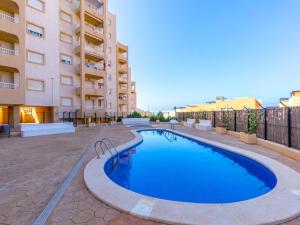 a swimming pool in front of a building at Apartment El Pinar de San Ginés by Interhome in La Azohía
