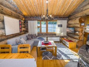 ein Wohnzimmer mit Sofa und Tisch in der Unterkunft Holiday Home Kelokanerva by Interhome in Rukatunturi 