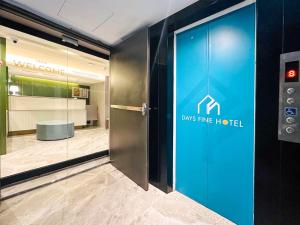 a door in a lobby with a dossine hotel sign at Days Fine Hotel in Kaohsiung