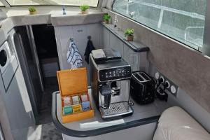 a coffee maker sitting on a counter in an rv at Nuits insolites sur un bateau 12m en pleine nature in Bully