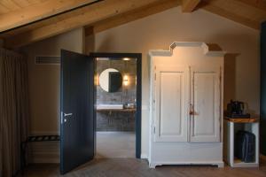an open door in a bathroom with a sink at GardaZen Suites - luxury - adults only in Caprino Veronese