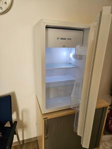 an empty refrigerator with its door open in a room at Krämerbrückenidyll in Erfurt