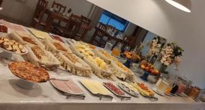 a table filled with lots of different types of food at Hotel Blanner in Charqueadas