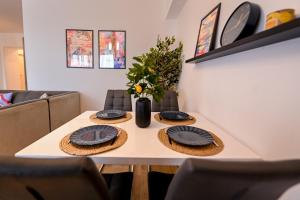 a table with two plates on top of it at Amazing Stay - Modern 1BR with Balcony in Aviatiei in Herăstrău