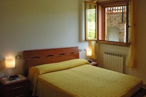 Кровать или кровати в номере Agriturismo Podere Gozzuto
