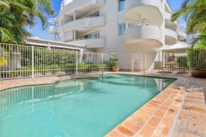 a swimming pool in front of a building at Seashells Sweet Retreat 450m walk to CBD in Nelson Bay