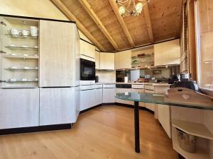 代米考迪亚Appartement Duplex 2 pièces, 4 couchages, proche pistes de ski, garage, Demi-Quartier - FR-1-597-16的一间大厨房,配有白色的橱柜和一张桌子 更多9张照片