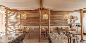 a restaurant with wooden walls and tables and chairs at Shoreline Retreat 900m to the beach in Fingal Bay