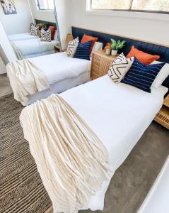 two beds in a room with pillows at Ocean View Townhouse in Dunmore