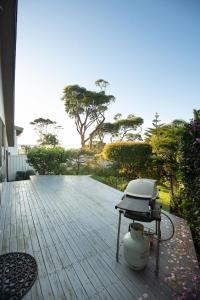 a grill sitting on top of a wooden deck at Ocean Views Walk to Malua Beach EV & Pet Friendly in Malua Bay