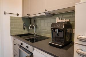a kitchen with a coffee maker on the counter at LUXURY at Rosenthaler Platz in Berlin +17 photos