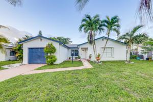 a white house with palm trees in front of it at Boca Raton Home Outdoor Kitchen, By Golf Courses in Boca Raton