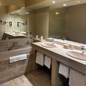 a bathroom with two sinks and a large mirror at LE SOLEIL D'OR in Joinville