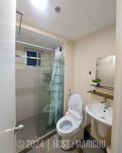 a bathroom with a shower and a toilet and a sink at AVIDA TOWERS RIALA 2BR Condo in IT Park Cebu City in Carreta