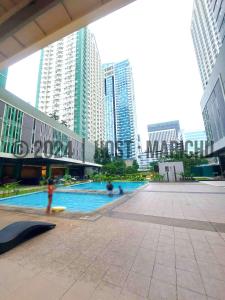 a swimming pool in a city with tall buildings at AVIDA TOWERS RIALA 2BR Condo in IT Park Cebu City in Carreta