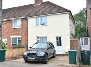 a car parked in front of a house at 4B4B Entire House Sleeps 11 Driveway Parking near Coventry University and City Centre in Coventry