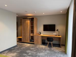a room with a desk with a television and a chair at Compass Travel in Kuygenzhar