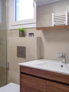 a bathroom with a sink and a window at Pietra Sole Suites in Ierapetra