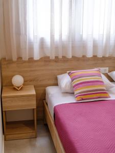 a bedroom with two beds and a window at Pietra Sole Suites in Ierapetra