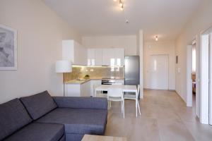 a living room with a couch and a table and a kitchen at Pietra Sole Suites in Ierapetra +34 photos