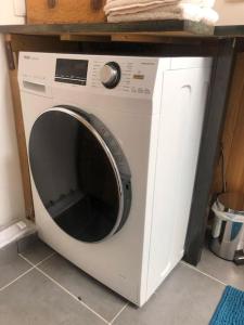 a white washing machine sitting in a kitchen at Le Loft Cosy - Centre ville - Cadre Royal in Sète