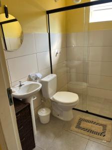 a bathroom with a toilet and a sink and a shower at Apto. em Conceição dos Ouros MG in Conceição dos Ouros +19 photos
