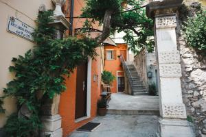 an alley with an entrance to a building with a staircase at the lake room in Nago-Torbole