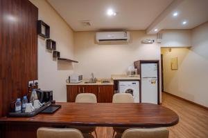 a room with a table and chairs and a kitchen at مسكن نال in Abha +63 photos