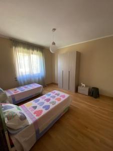 a bedroom with two beds in a room at Al Bricco dei Frati in Dogliani