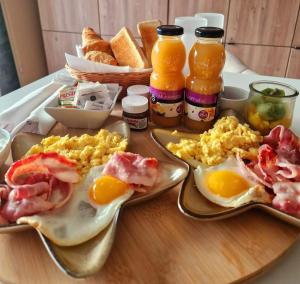 a breakfast table with eggs and bread and drinks at A Loffre Zen in Loffre +12 photos