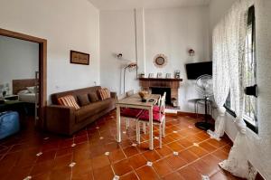 a living room with a couch and a table at Finca Dos Vientos Tarifa in Tarifa