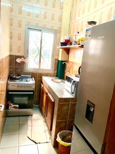 a small kitchen with a stove and a window at Luxury apartment Yaoundé in Mimboman