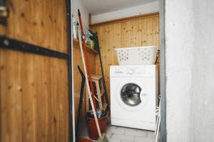 a laundry room with a washer and a washing machine at the lake room in Nago-Torbole