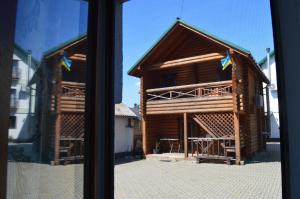 a view of a log cabin from a window at Садиба "Мапа" in Berehove