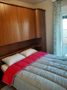 a bedroom with a bed with a wooden headboard at Blekkerke 57 in Koksijde