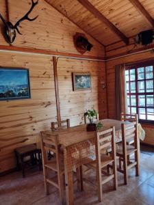 a dining room with a table and chairs in a cabin at Cabañas Carayá in Paso de la Patria +9 photos
