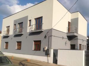 a white building with balconies on the side of it at Casa Don Felipe in Timişoara