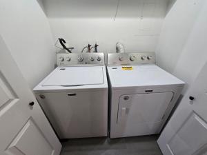 a kitchen with two white appliances in a room at Turkey Trot, Cabin Getaway on Lake w/ Hot Tub in Streetsboro +38 photos