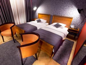 a hotel room with two beds and two lamps at Park Boutique Hotel in Varaždin