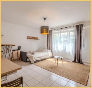 a living room with a bed and a table at Le Salève I Studio I Etrembières in Monnetier-Mornex