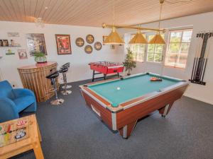 a living room with a pool table in it at Luxury Lodge with Limfjord View - By Traum Ferienwohnungen in Spottrup
