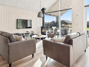 a living room with two couches and a tv at Luxury Retreat in Romo - By Traum Ferienwohnungen in Kongsmark