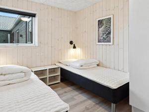 a bedroom with two beds and a window at Luxury Retreat in Romo - By Traum Ferienwohnungen in Kongsmark +34 photos