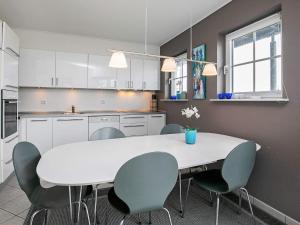 cocina con mesa blanca y sillas en 8 person holiday home on a holiday park in Bogense, en Bogense