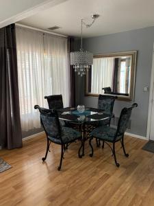 a dining room with a black table and chairs at Charming 3 bed 3 bath home, super cozy, close to DIA in Altura