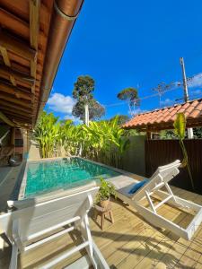 a patio with a pool and a chair and a table at Villa Milagre in Trancoso